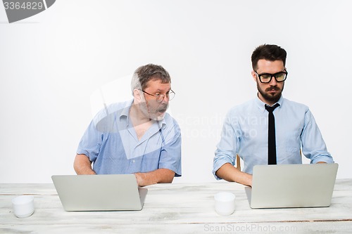 Image of The two colleagues working together at office on white background