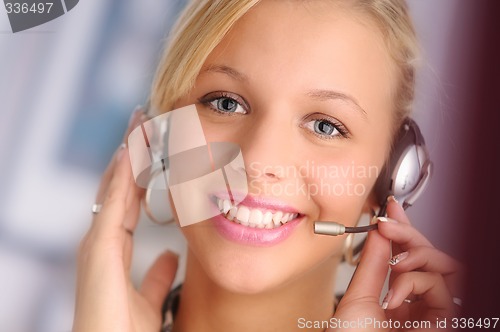 Image of young pretty sexy blond hair operator with headset