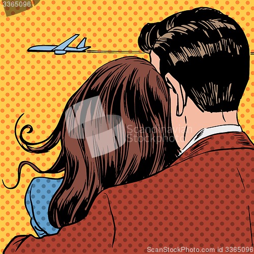 Image of Loving couple looking at a plane taking off in the sky