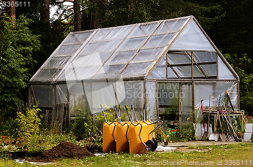 Image of winter garden, wheelbarrows and garden equipment