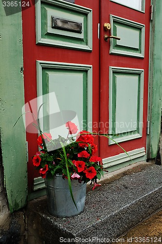 Image of door, mailbox and a bucket of flowers