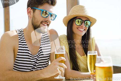 Image of Friends drinking a cold beer