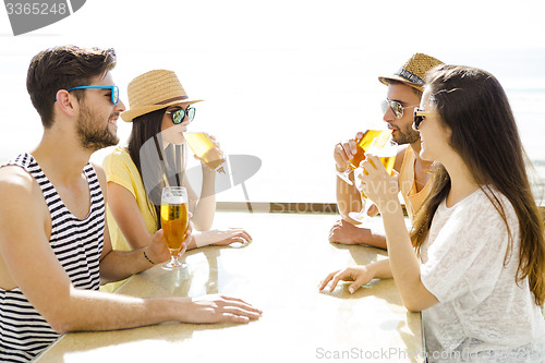 Image of Friends drinking a cold beer