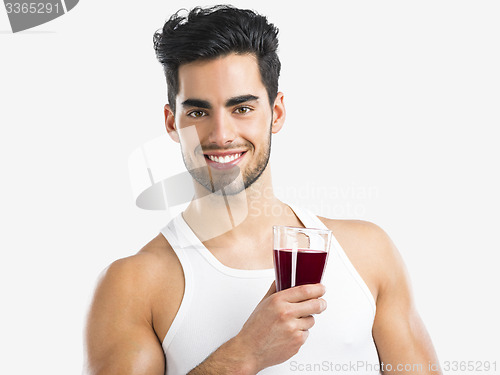 Image of Athletic man drinking a juice