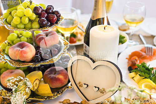 Image of Wedding table with candle and heart-shaped decoration