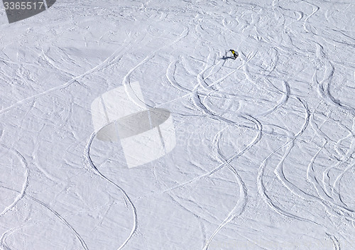 Image of Snowboarder downhill on off piste slope with newly-fallen snow