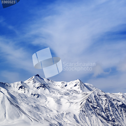 Image of Winter snowy mountains at sun windy day