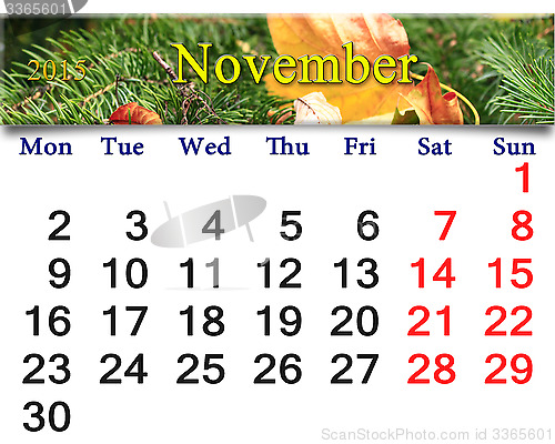Image of calendar for November of 2015 with leaf and spruce
