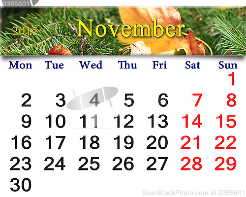 Image of calendar for November of 2015 with leaf and spruce