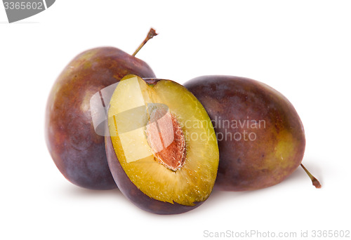 Image of Half and two violet plums
