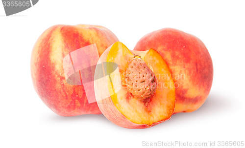 Image of Two whole and half of peach