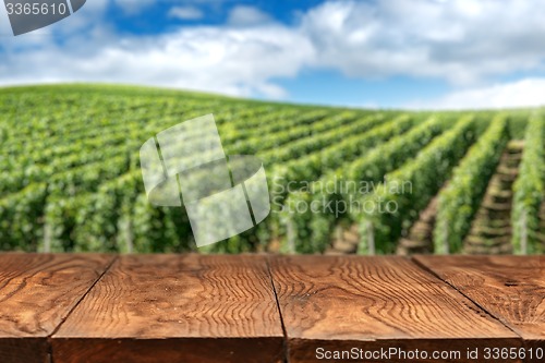 Image of wooden table with vineyard landscape