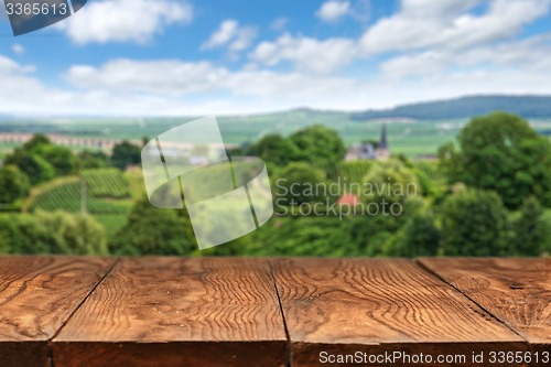 Image of wooden table with vineyard landscape