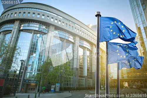 Image of European union flag against parliament in Brussels