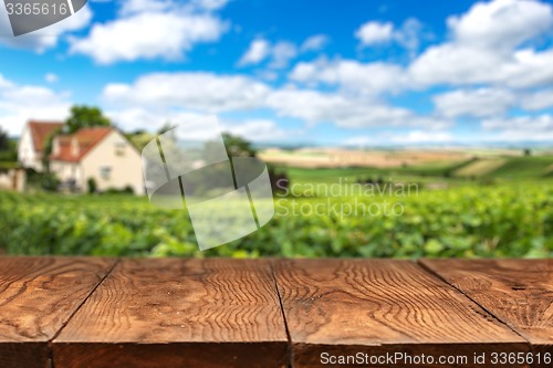 Image of wooden table with vineyard landscape