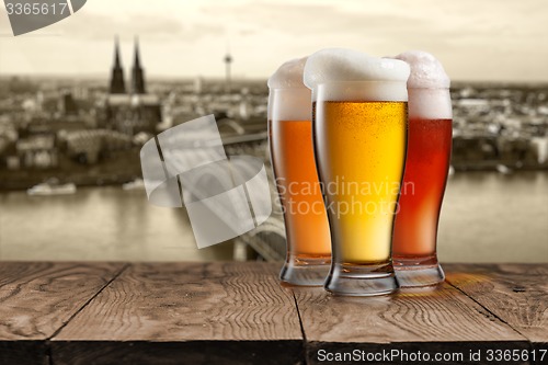 Image of Glass of beer with view of Koeln on background