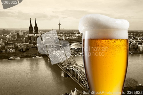 Image of Glass of beer with view of Koeln on background