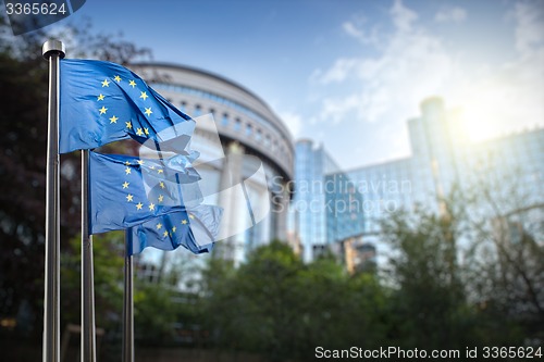 Image of European union flag against parliament in Brussels