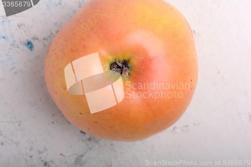 Image of apple on old white plate