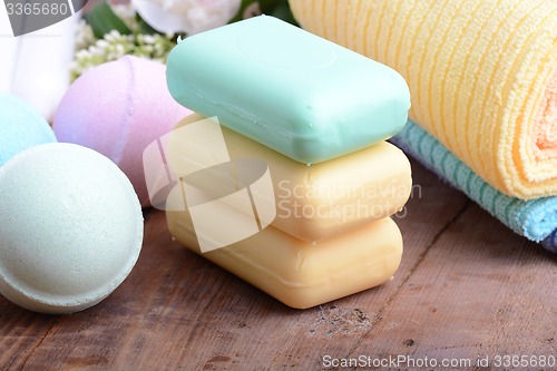 Image of towels set, aroma therapy, soap and sea salt on wooden plate 