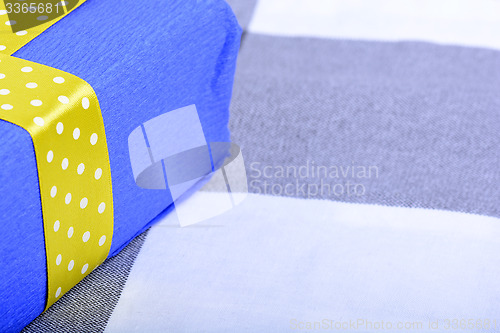 Image of blue gift box with yellow ribbon