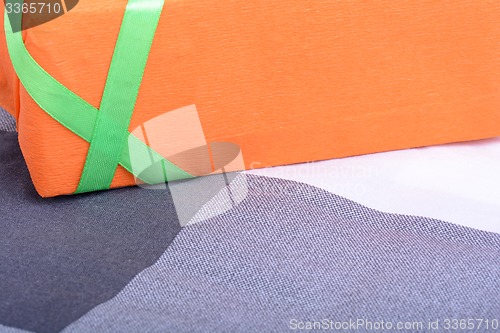 Image of orange gift box with green ribbon