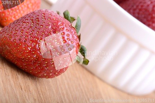 Image of Close up strawberry on wooden plate