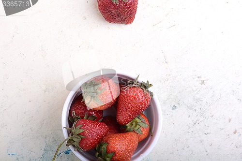 Image of Close up strawberry on old watercolor plate