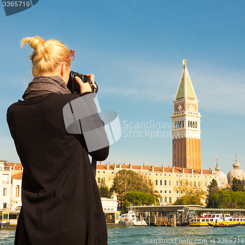 Image of Female tourist taking photo of Venice.