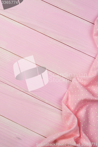 Image of Pink towel over wooden table