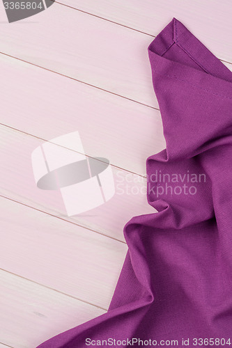 Image of Purple towel over wooden table