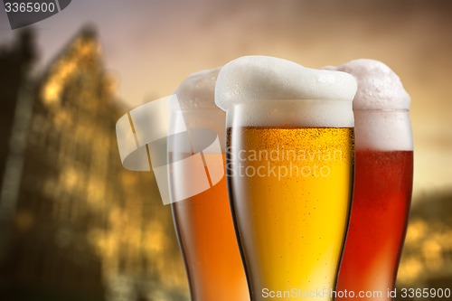 Image of Glasses of beer against blurred european city