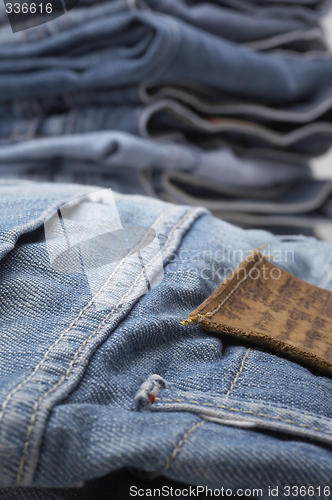 Image of the heap of modern designer blue jeans