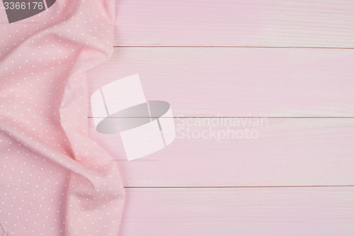 Image of Pink towel over wooden table