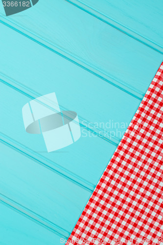 Image of White and red towel over wooden table