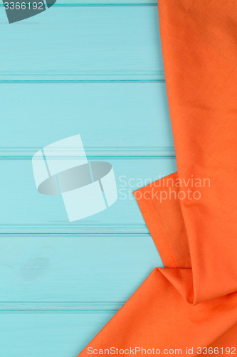 Image of Orange towel over wooden table