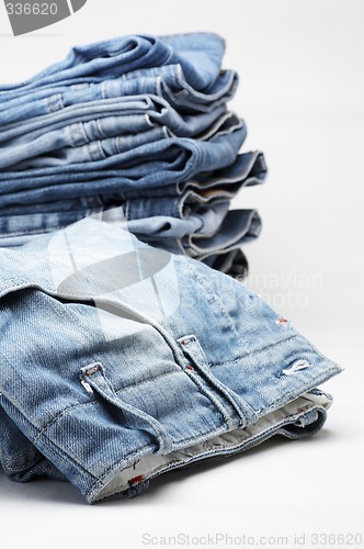 Image of the heap of modern designer blue jeans