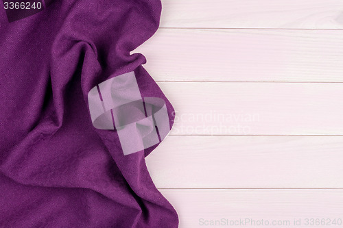 Image of Purple towel over wooden table