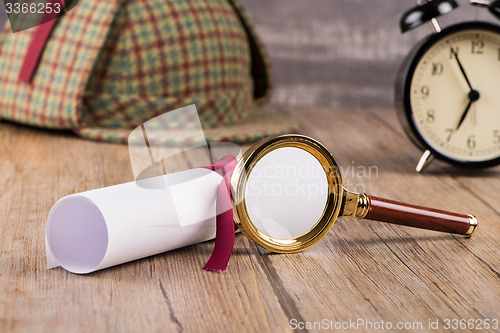 Image of Wrapped paper sheets and magnifying glass