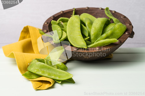 Image of Snow peas on wooden bowl