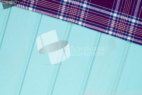 Image of Purple towel over wooden table