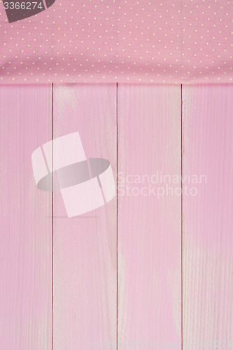 Image of Pink towel over wooden table