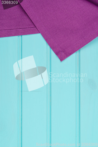 Image of Purple towel over wooden table