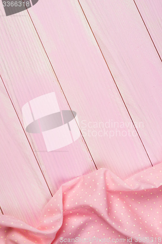 Image of Pink towel over wooden table