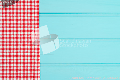 Image of White and red towel over wooden table
