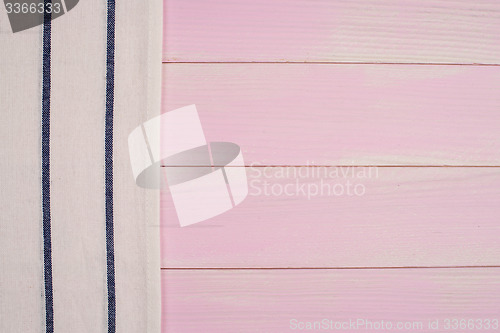 Image of White and blue towel over wooden table