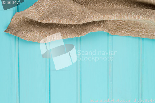 Image of Beige and white towel over table