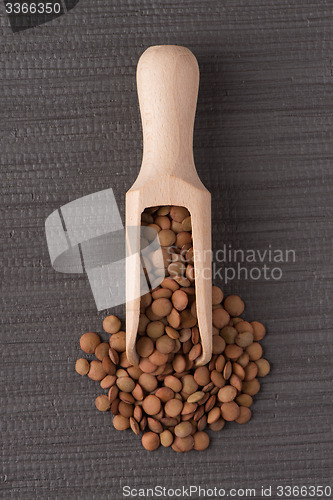 Image of Wooden scoop with lentils