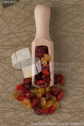 Image of Wooden scoop with mixed dried fruits