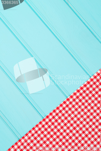Image of White and red towel over wooden table